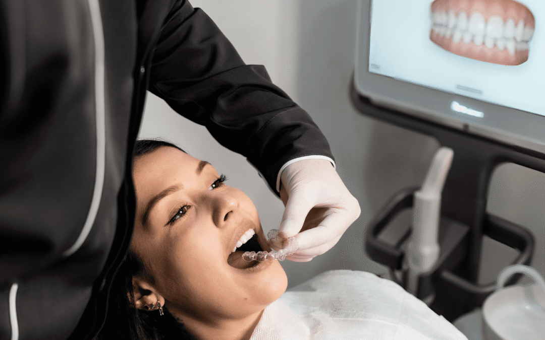 female dental patient having clear aligners fitted by dentist